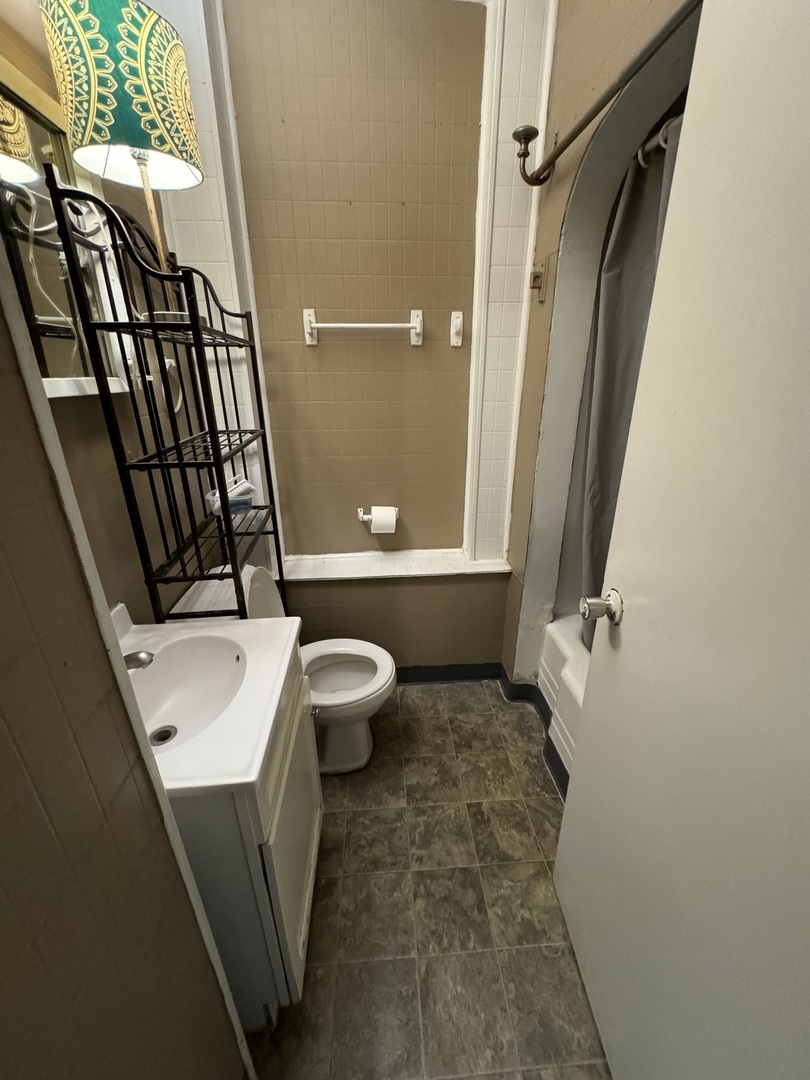 1112 Market Street DeKalb, IL 60115 - Photo 11 of 18 a bathroom with a sink a toilet a mirror and shower