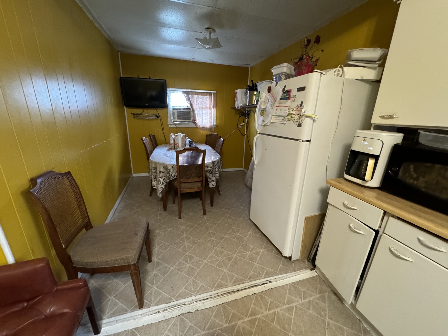 1112 Market Street DeKalb, IL 60115 - Photo 10 of 18 a living room with furniture and a refrigerator