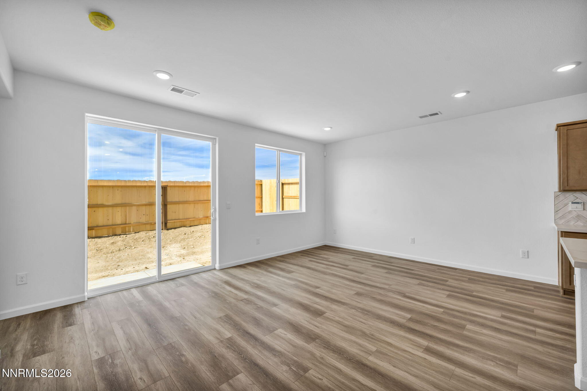 6676 Morgan Mill Road, Unit HOMESITE 14 Carson City, NV 89701 - Photo 8 of 24 an empty room with wooden floor and windows
