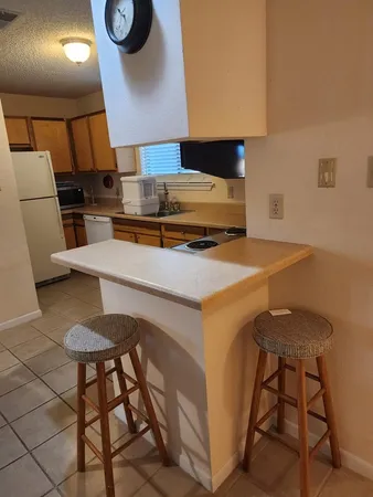 a kitchen with a table chairs and a stove