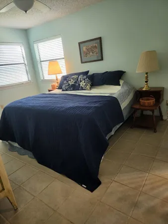 a bedroom with a bed and a painting on the wall