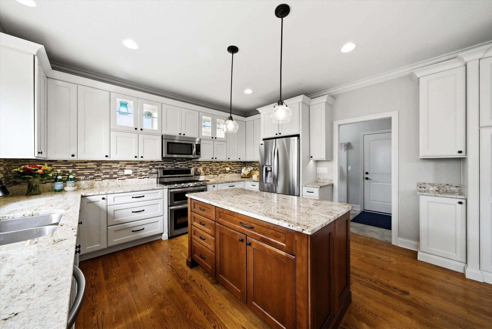 2061 Windham Circle Wheaton, IL 60187 - Photo 6 of 35 a kitchen with stainless steel appliances granite countertop a refrigerator a sink dishwasher a stove and white cabinets with wooden floor