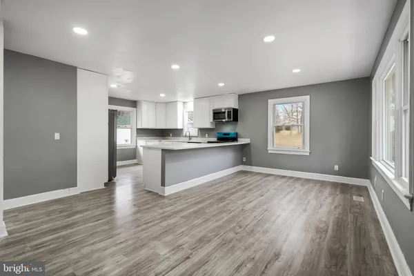 a view of kitchen with wooden floor and windows