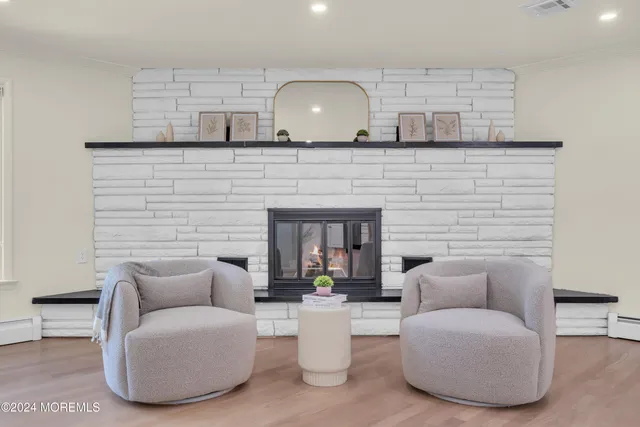 a view of a dining room with furniture a chandelier and wooden floor