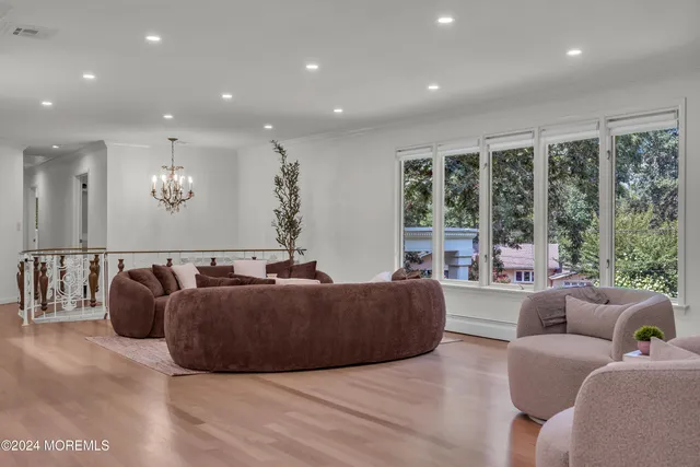 a view of a dining room with furniture and chandelier
