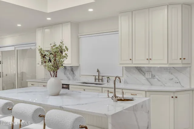 a kitchen with a sink and a mirror
