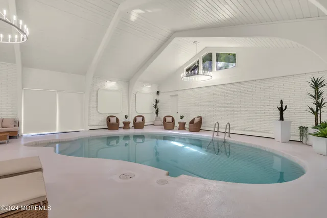 a bedroom with a bed and a wall painting