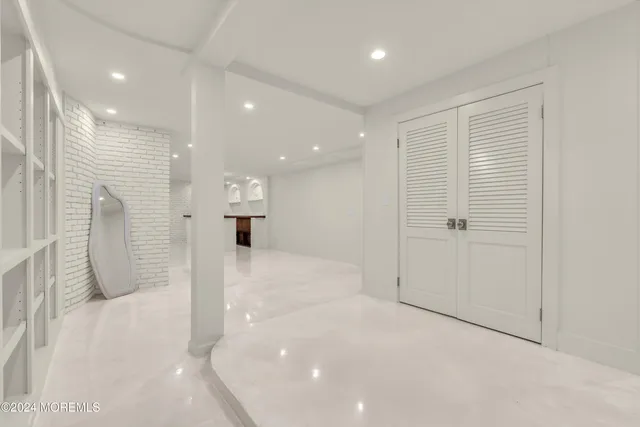 an aerial view of residential house with outdoor space and trees all around