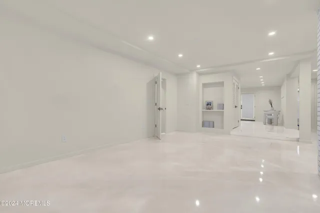 an aerial view of residential house with outdoor space and trees all around