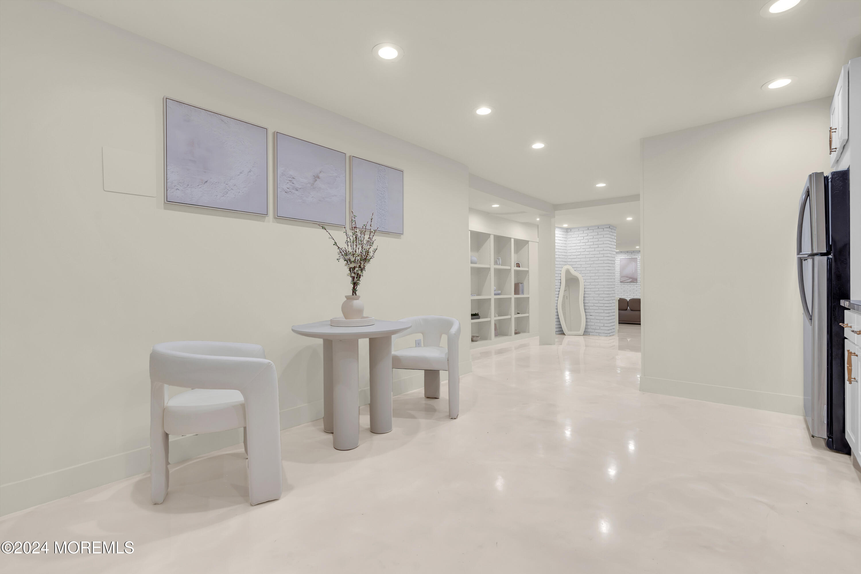7 Lakeview Drive Jackson, NJ 08527 - Photo 50 of 67 a view of a hallway with a chair and a refrigerator