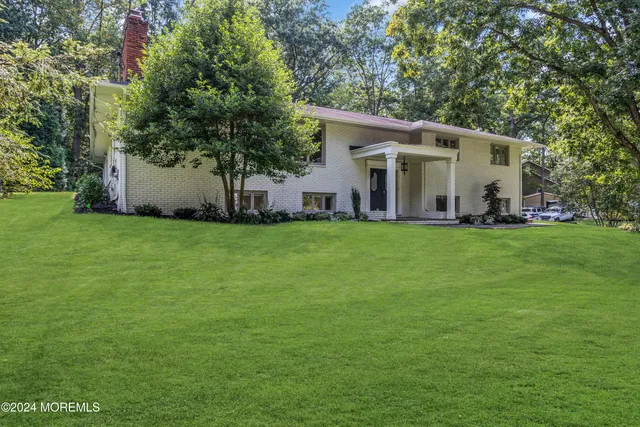 a view of a house with a yard and sitting area