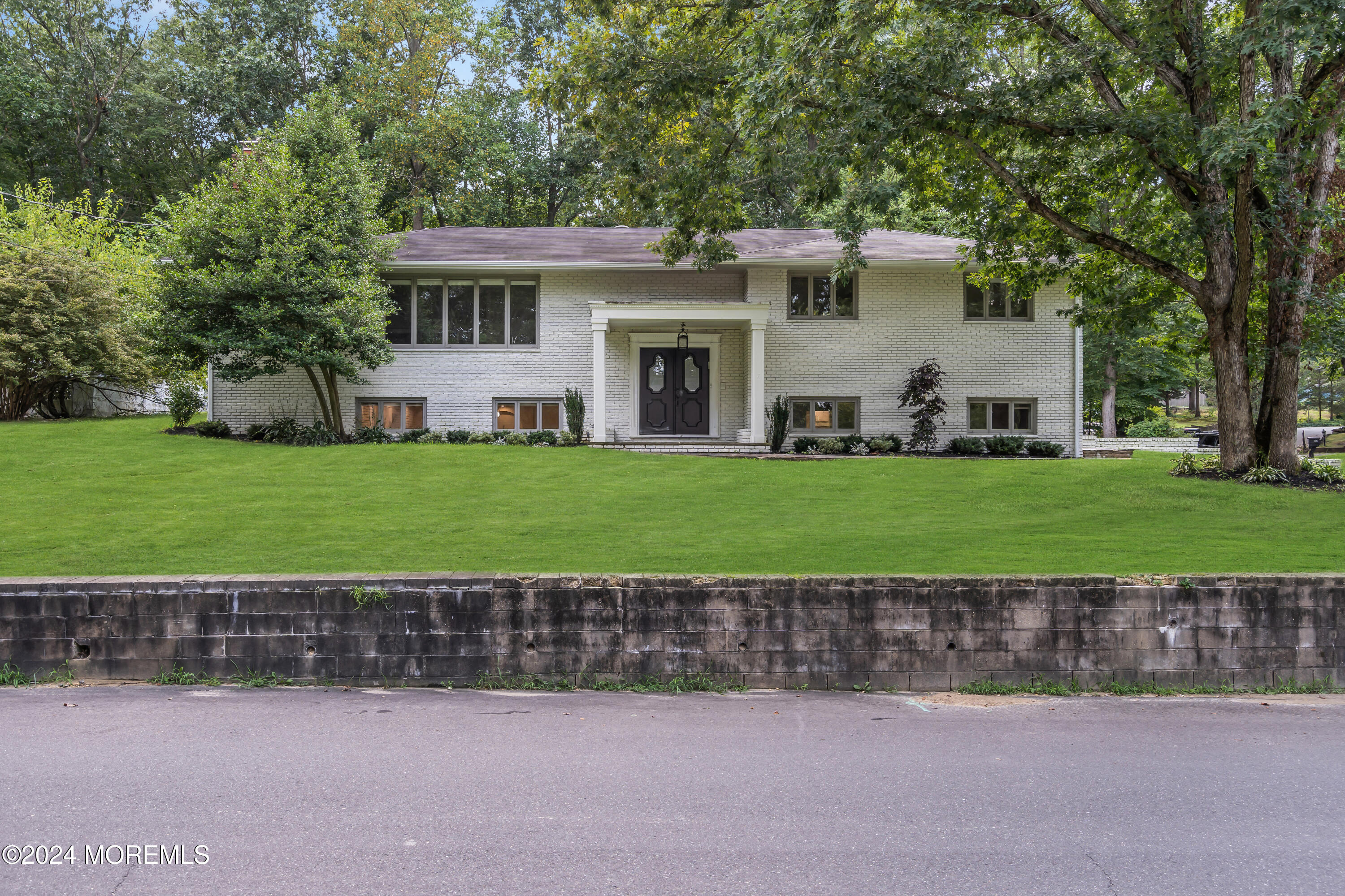 7 Lakeview Drive Jackson, NJ 08527 - Photo 6 of 67 a front view of a house with a garden and a tree
