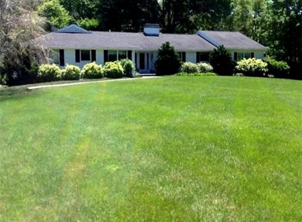 20 Deerhaven Road Lincoln, MA 01773 - Photo 1 of 25 a front view of a house with a yard and garage