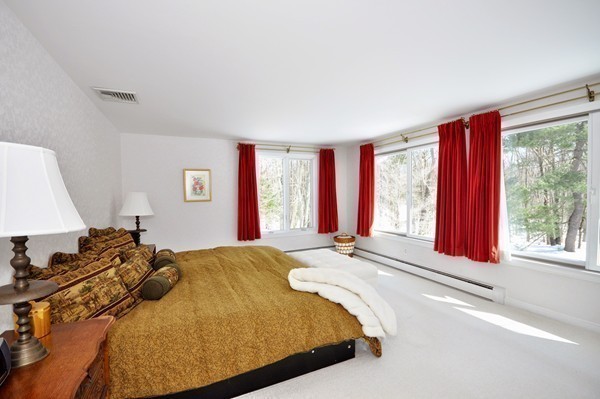 20 Deerhaven Road Lincoln, MA 01773 - Photo 15 of 25 a bed sitting in a bedroom next to a window