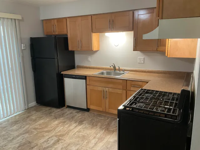 a kitchen with a refrigerator and a sink