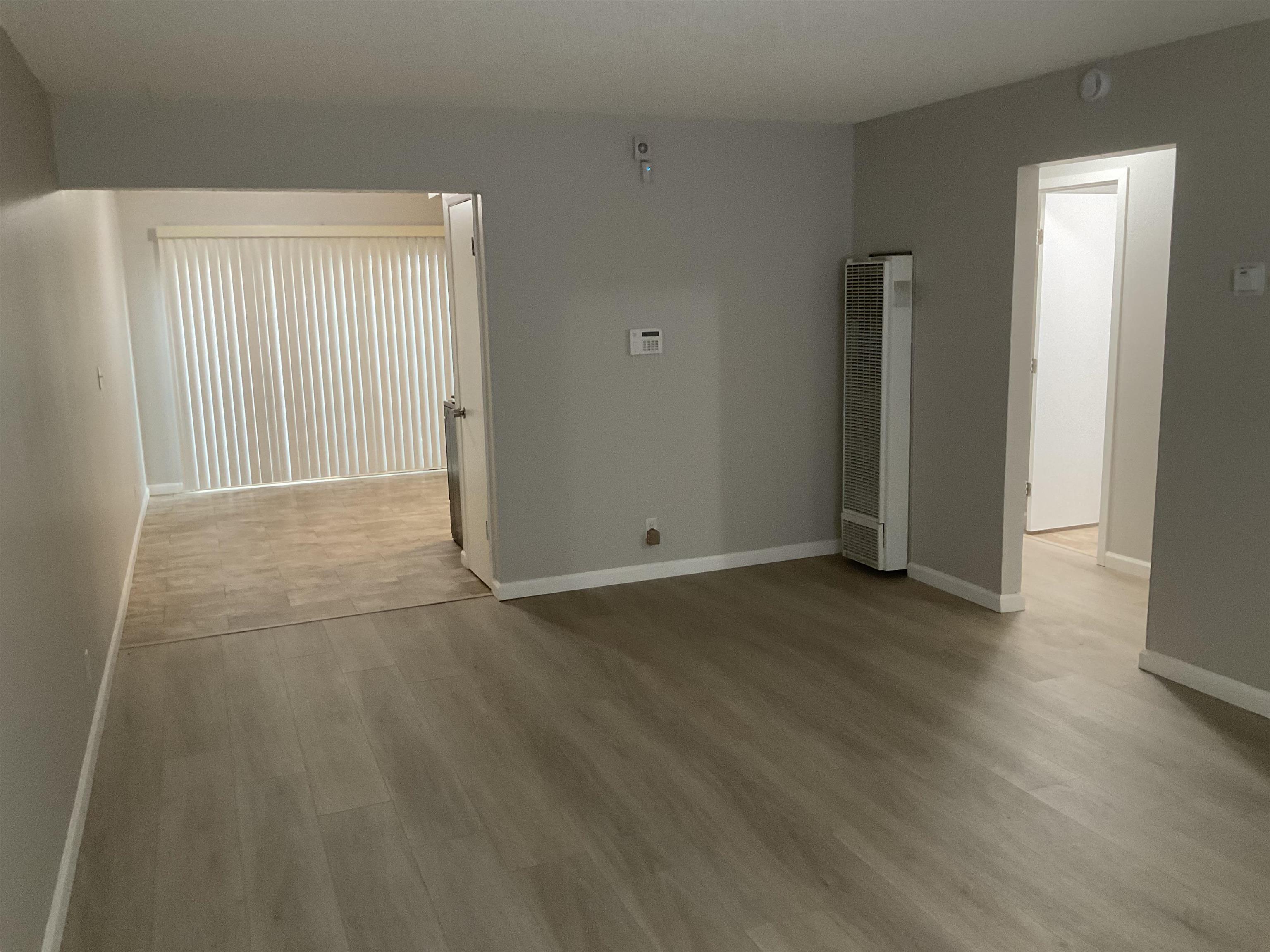 1108 West 5th Street, Unit 2 Antioch, CA 94509 - Photo 3 of 6 an empty room with wooden floor and windows