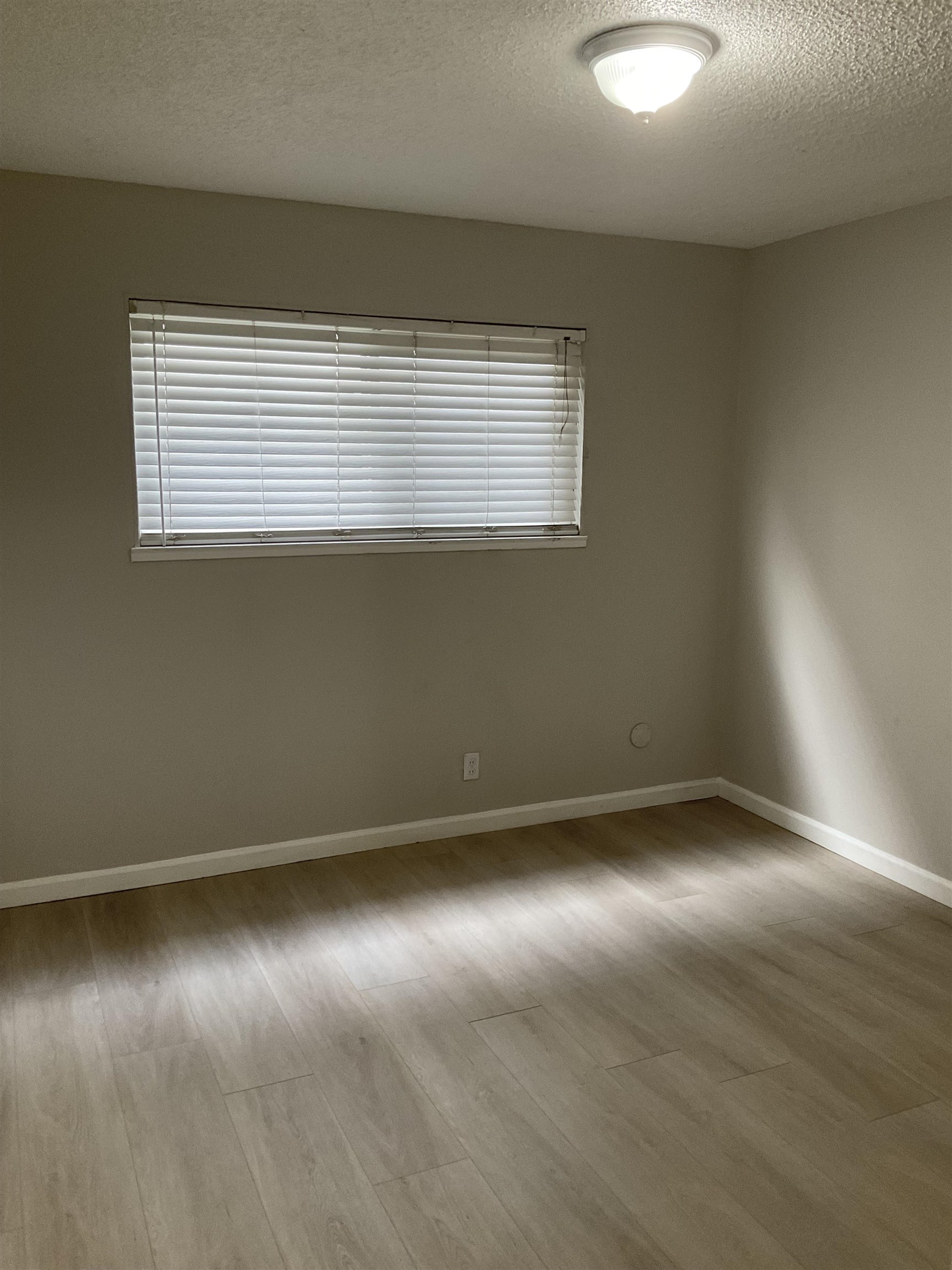 1108 West 5th Street, Unit 2 Antioch, CA 94509 - Photo 6 of 6 an empty room with wooden floor and windows