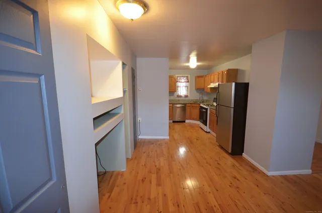 a view of kitchen and wooden floor