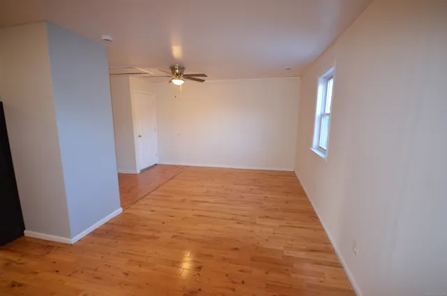 wooden floor in an empty room with a window