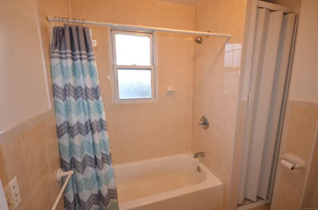 a bathroom with a bathtub and a shower