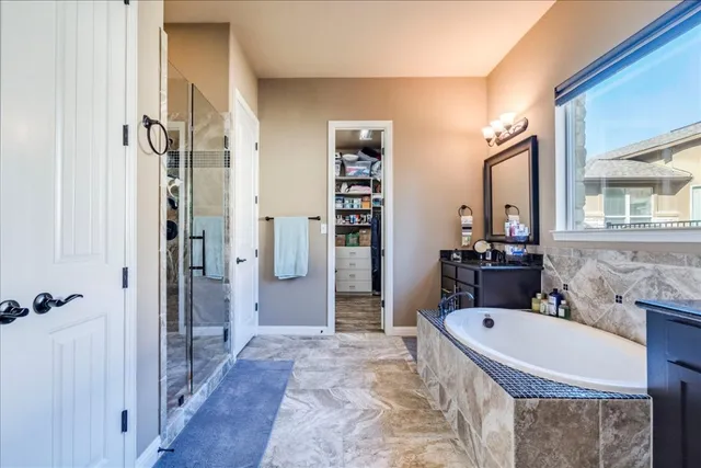 a bathroom with a tub sink and mirror