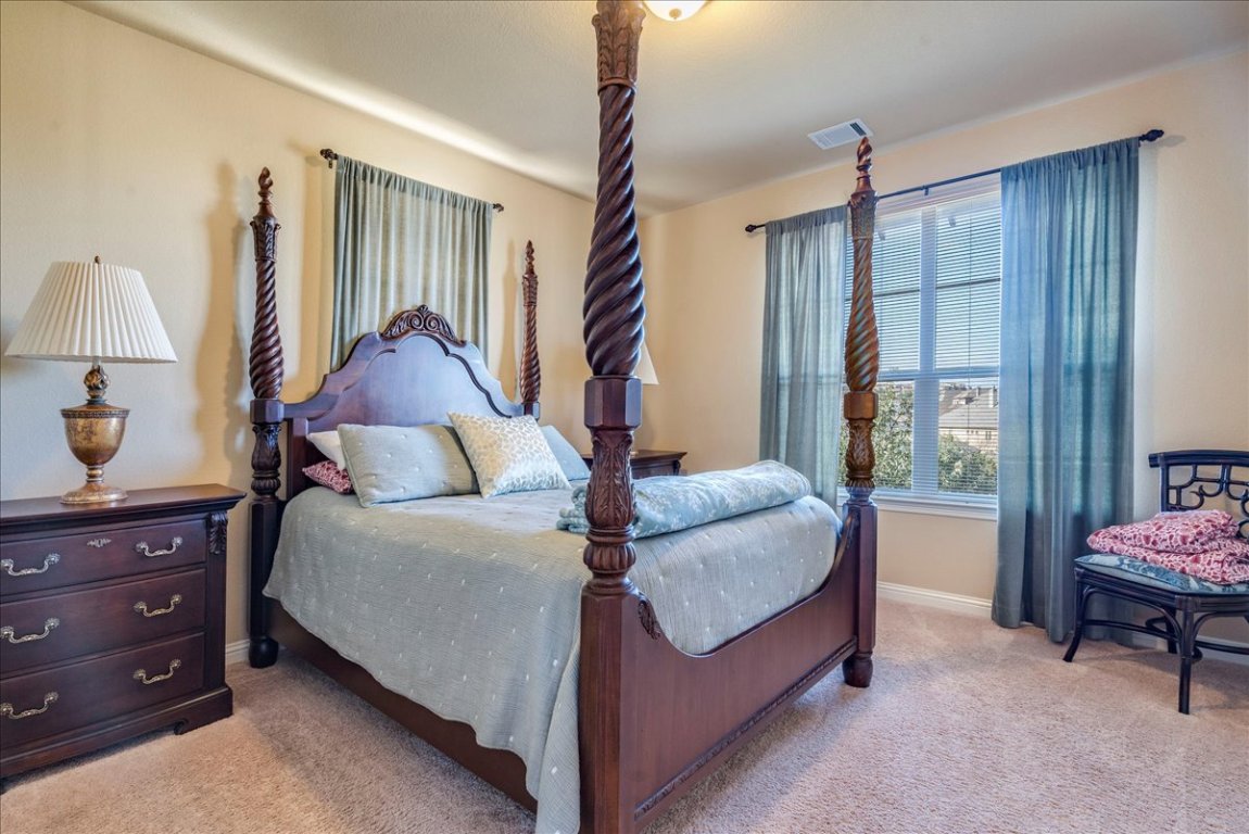 307 Duffy Lane Austin, TX 78738 - Photo 19 of 40 Carpeted bedroom with baseboards