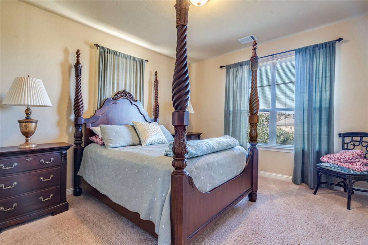 307 Duffy Lane Austin, TX 78738 - Photo 19 of 40 a bed room with a bed and a window