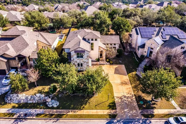 an aerial view of a houses with yard