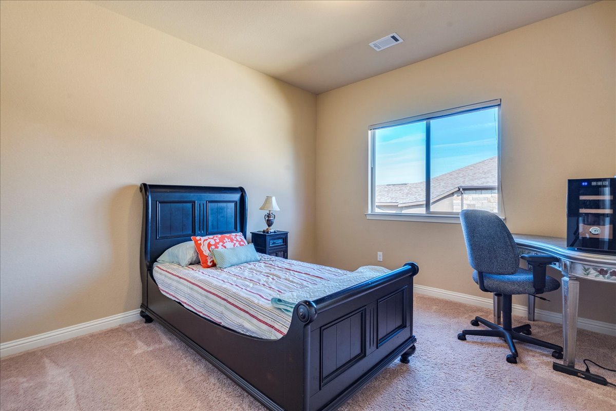 307 Duffy Lane Austin, TX 78738 - Photo 21 of 40 a bedroom with a bed and a desk