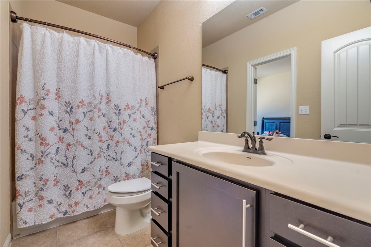 307 Duffy Lane Austin, TX 78738 - Photo 22 of 40 a bathroom with a sink toilet and shower