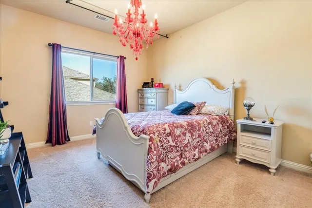 a bed room with a bed and a chandelier