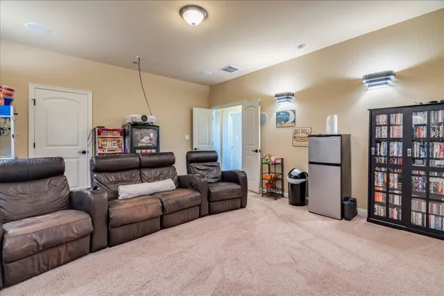 a living room with furniture and a ceiling fan