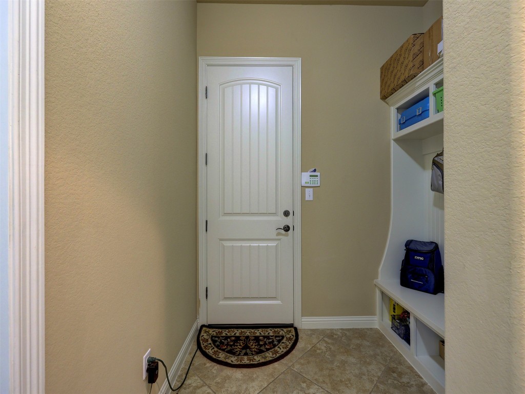 307 Duffy Lane Austin, TX 78738 - Photo 27 of 40 Mudroom featuring light tile patterned floors and baseboards