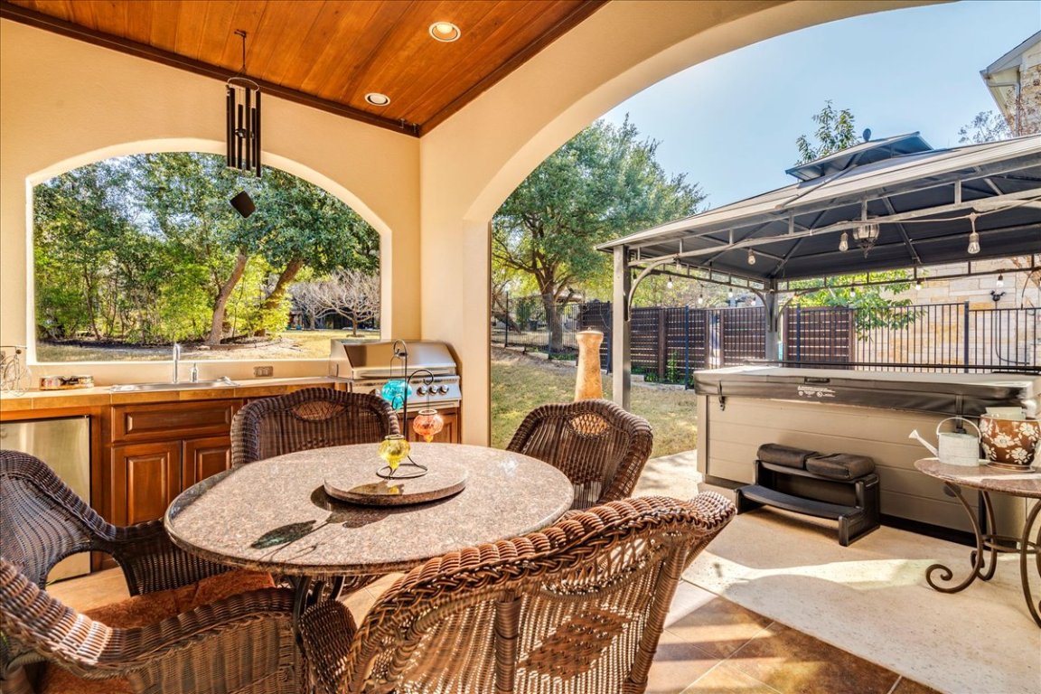 307 Duffy Lane Austin, TX 78738 - Photo 30 of 40 View of patio / terrace with outdoor dining space, a gazebo, exterior kitchen, and a hot tub
