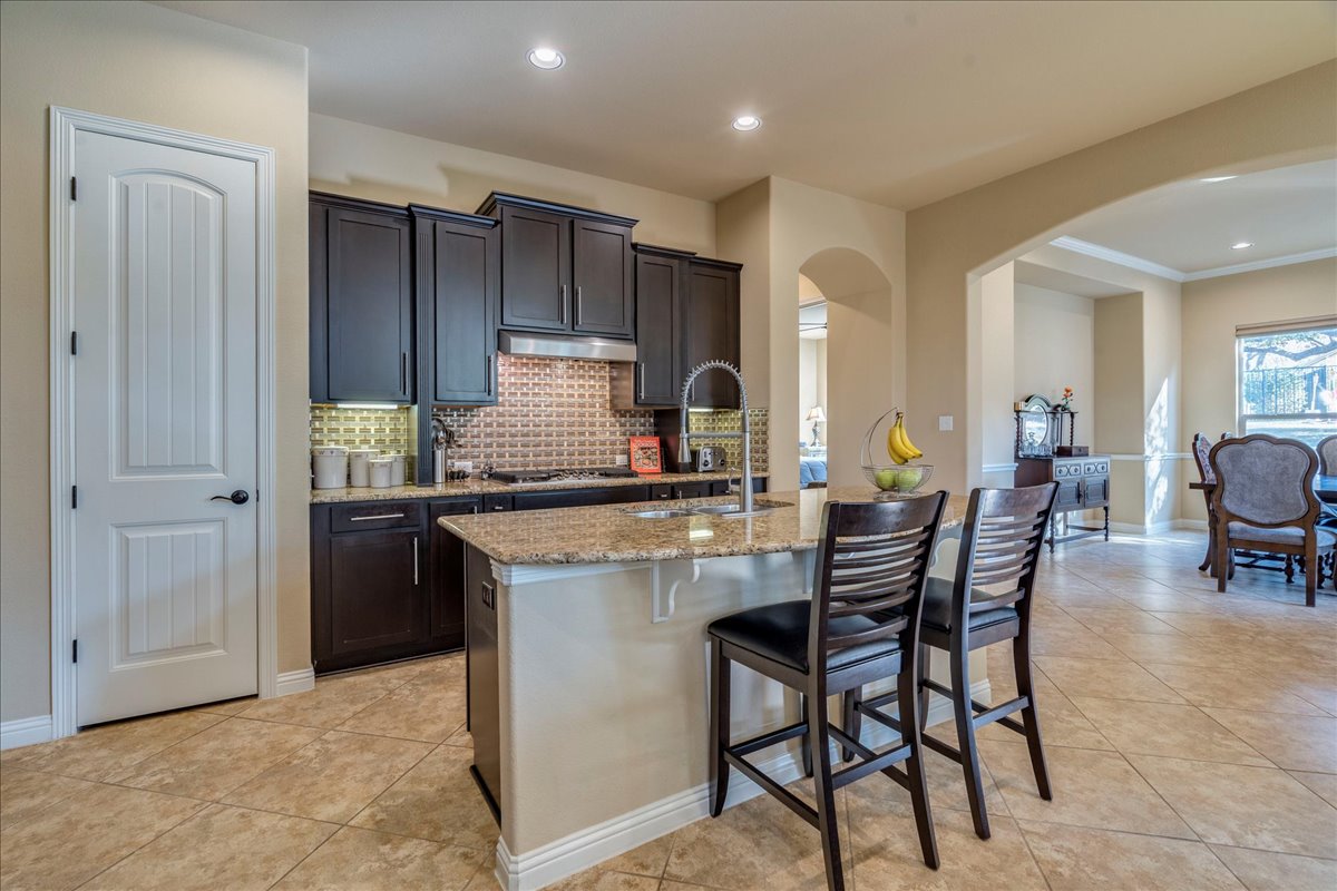307 Duffy Lane Austin, TX 78738 - Photo 8 of 40 a kitchen with a dining table chairs and refrigerator