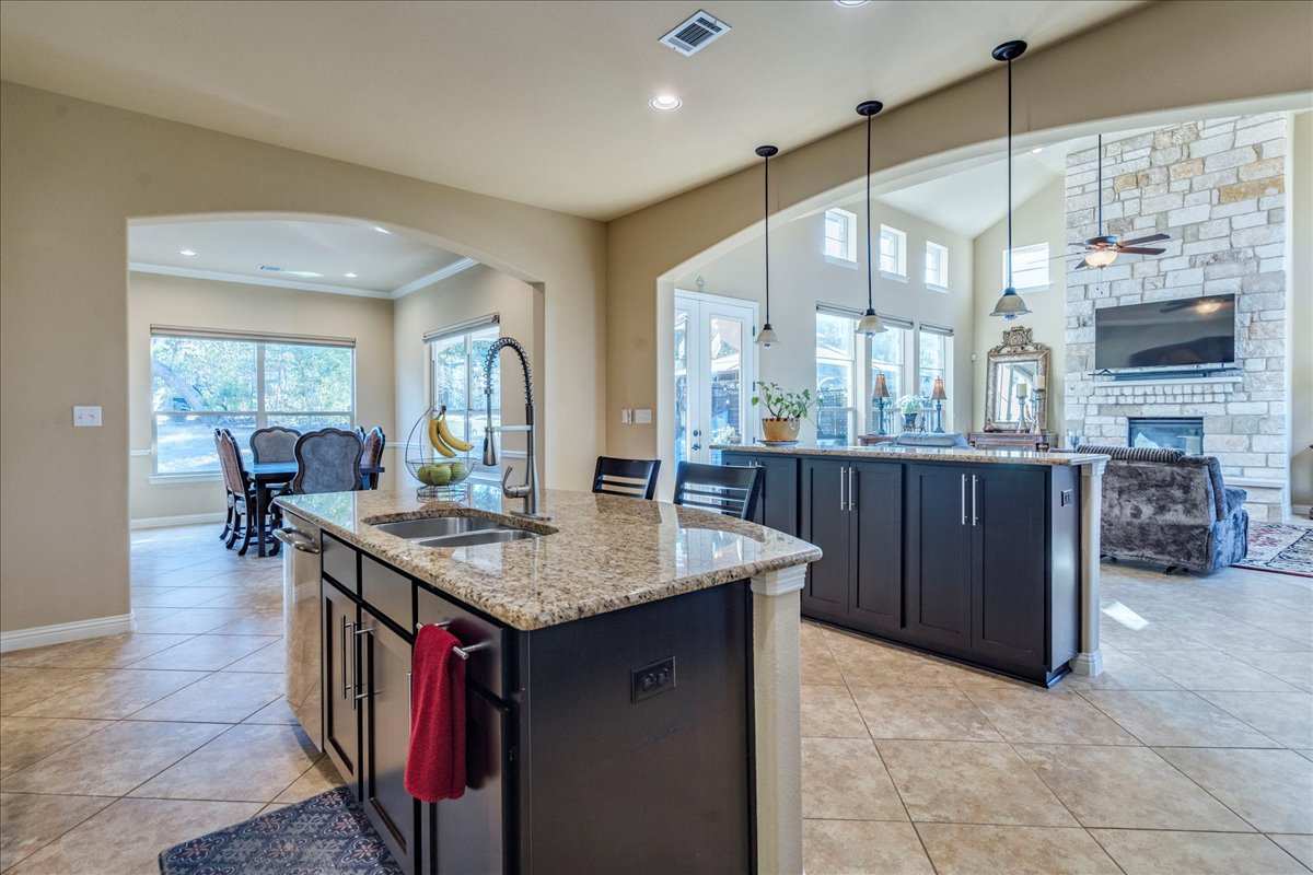 307 Duffy Lane Austin, TX 78738 - Photo 9 of 40 a dining hall with stainless steel appliances granite countertop a stove refrigerator and cabinets