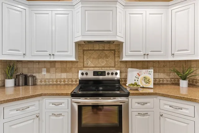 a stove top oven sitting inside of a kitchen