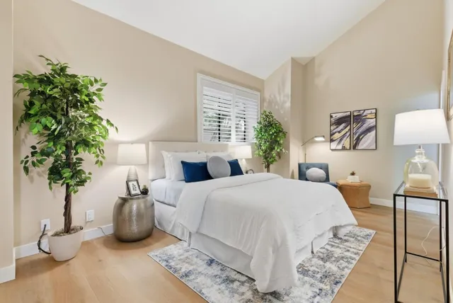 a bedroom with bed and a potted plant