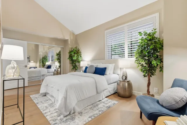 a bedroom with a bed and a potted plant