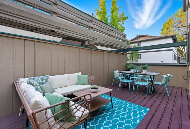 a backyard of a house with table and chairs