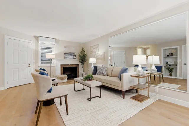 a living room with furniture a fireplace and a table