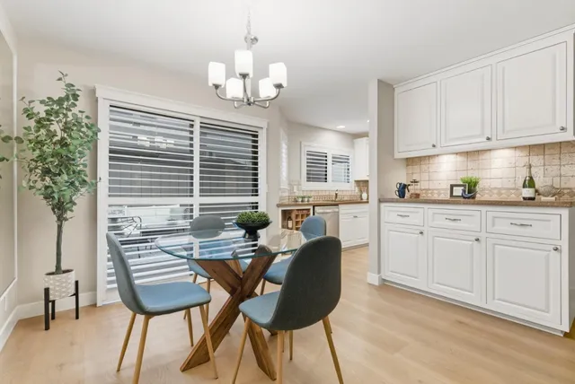 a kitchen with a table chairs and microwave