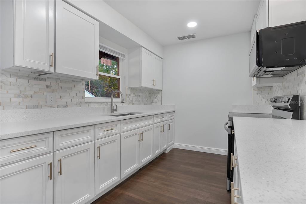 1213 Baranova Road Ocoee, FL 34761 - Photo 18 of 31 a kitchen with stainless steel appliances granite countertop a sink and a granite counter tops