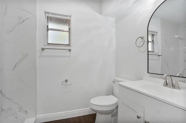 a bathroom with a sink toilet and vanity