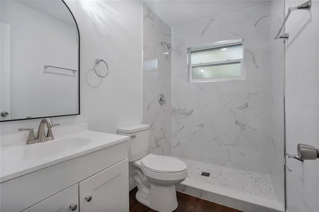 a bathroom with a sink toilet and shower
