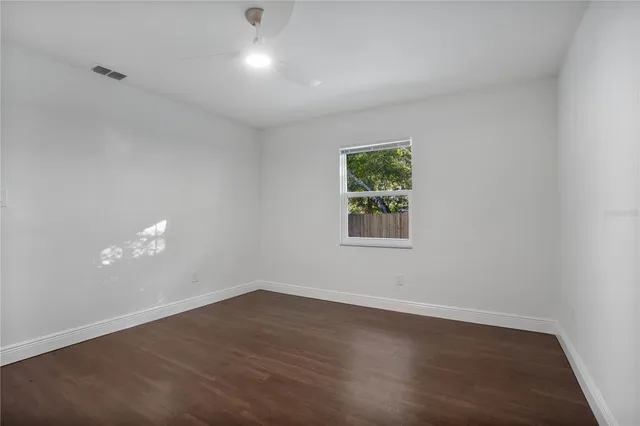 wooden floor in an empty room with a window