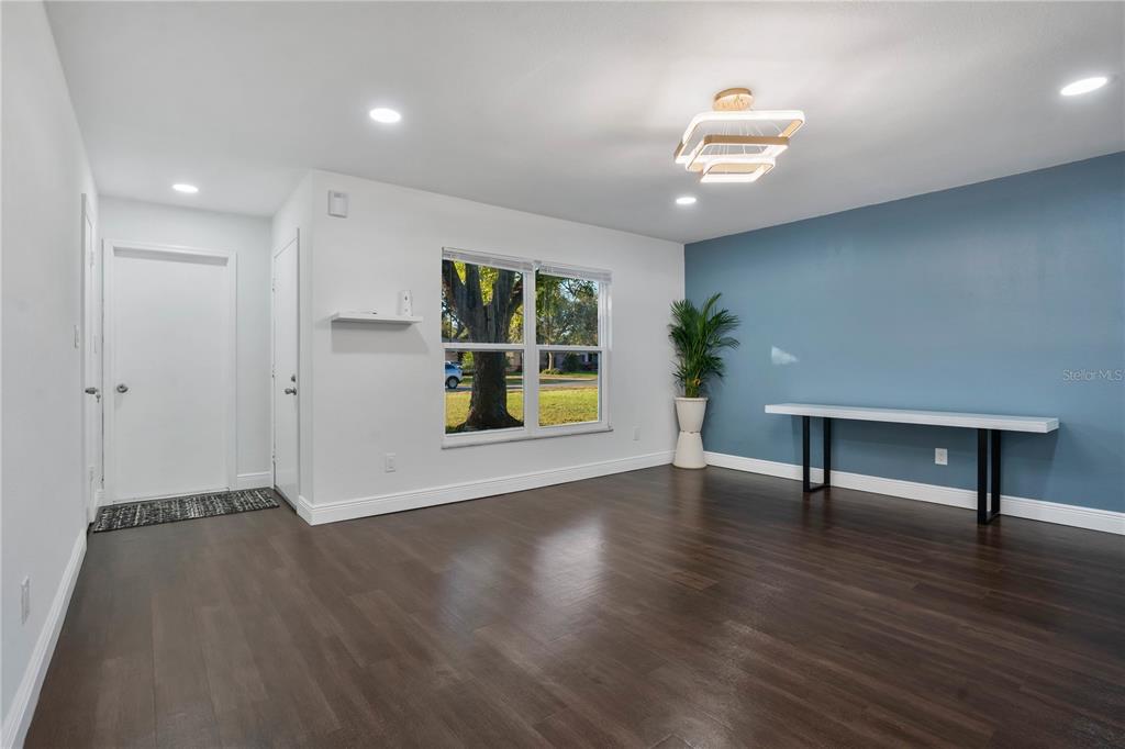 1213 Baranova Road Ocoee, FL 34761 - Photo 4 of 31 an empty room with wooden floor and windows