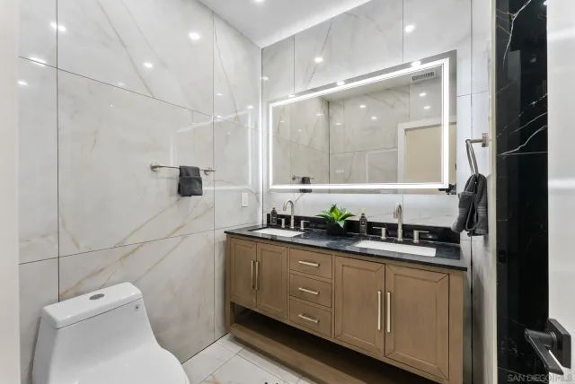 a bathroom with a sink a shower and a mirror