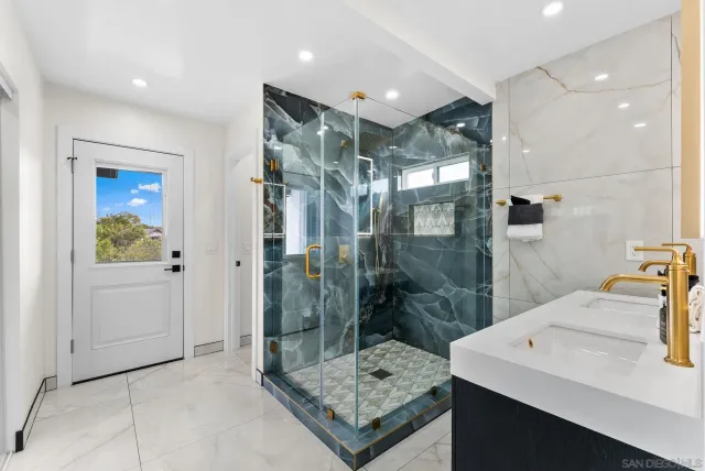 a bathroom with a shower sink and mirror