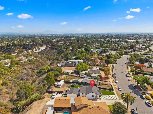 an aerial view of a house with a swimming pool